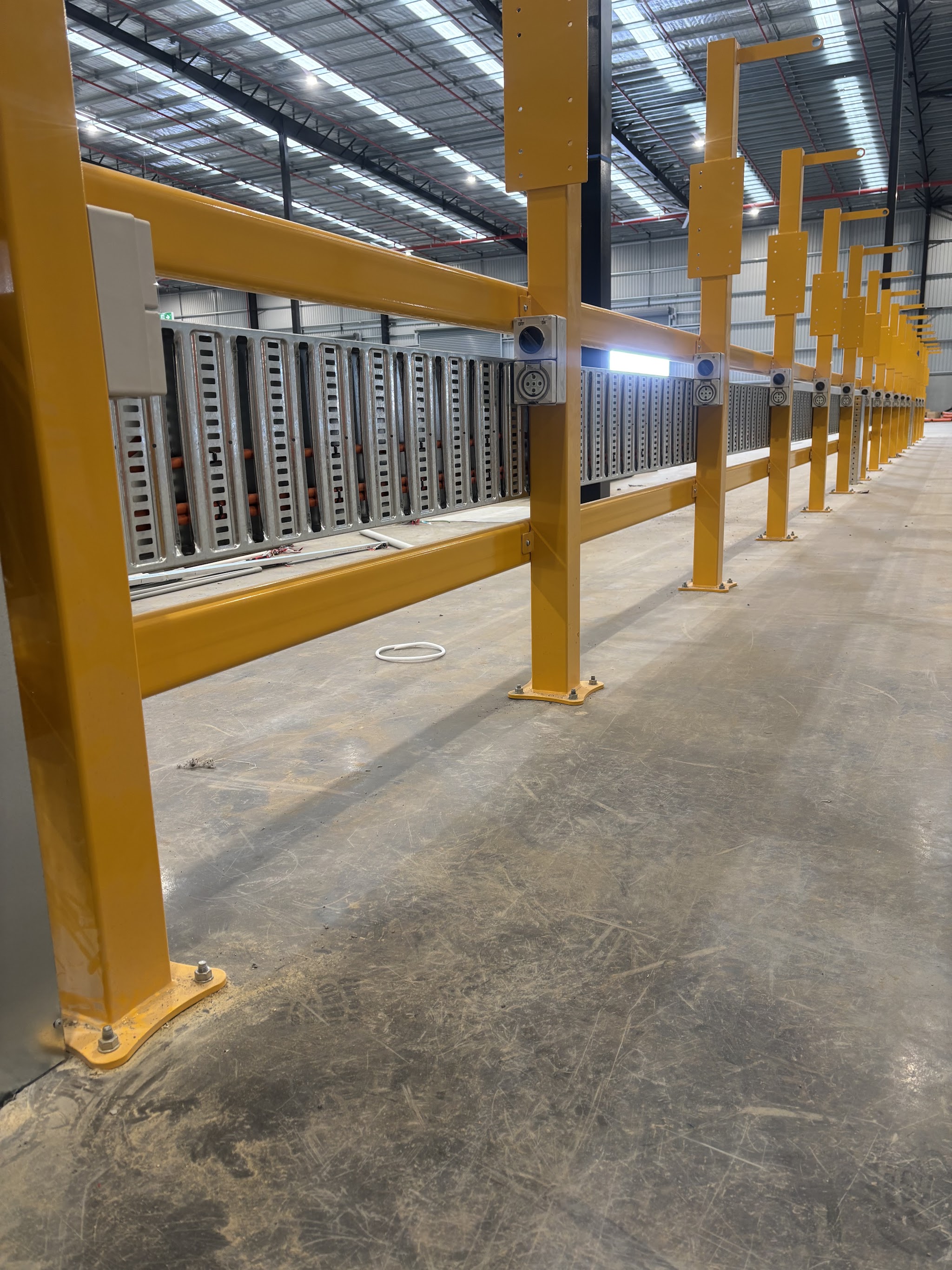 Warehouse interior with high bay lighting above steel racking