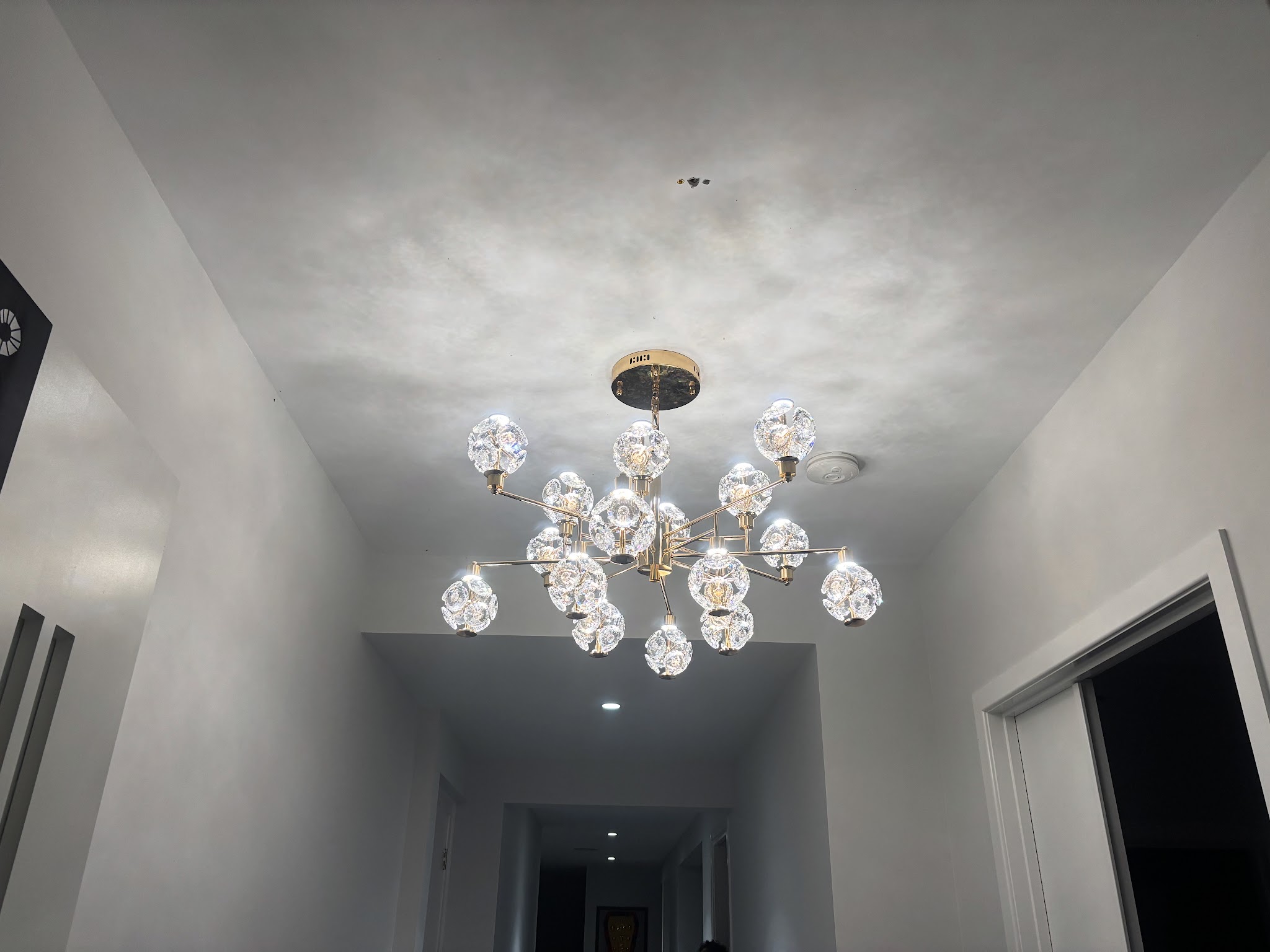 Hallway with a cluster pendant light and recessed downlights installed by DJZ Electrical